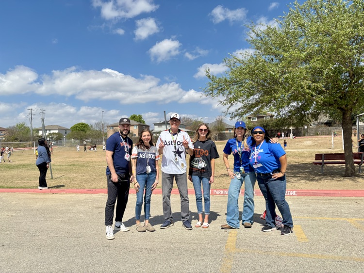 a group of teachers outside wearing different baseball team shirts
