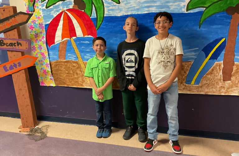 Three boys posing for a picture