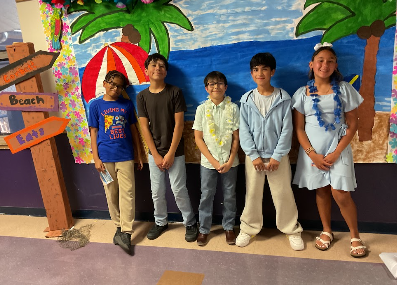 4 girls and one boy posing for picture