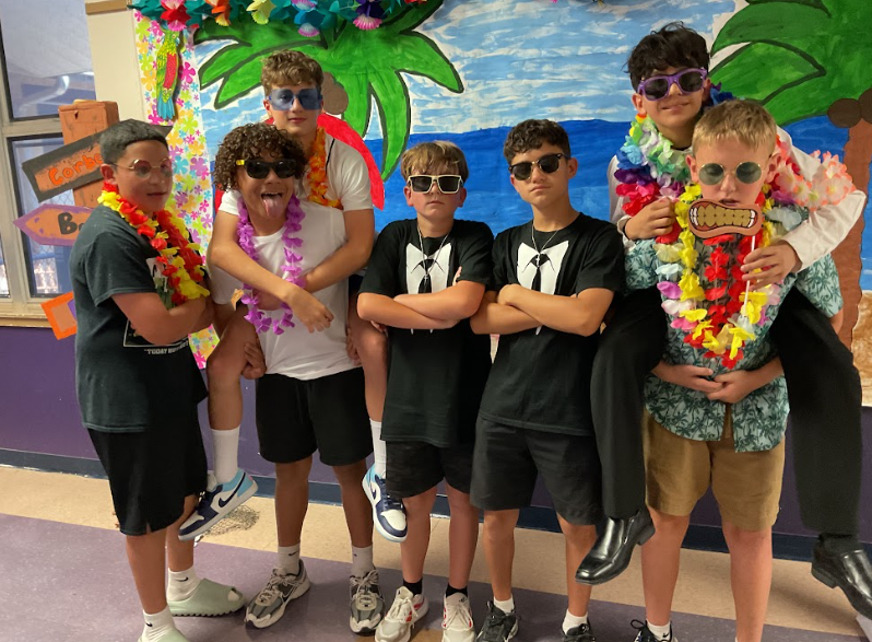 a group of boys with sunglasses posing for a picture