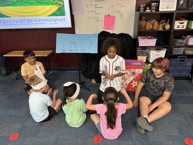 PreK students helping 4th graders with their service project.