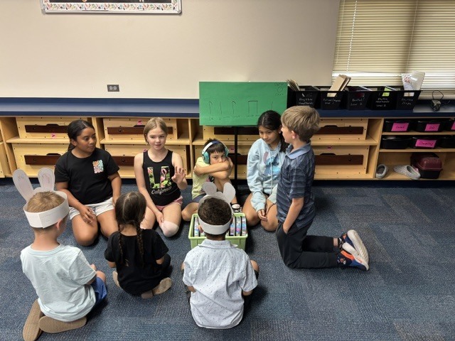 PreK students helping 4th graders with their service project.