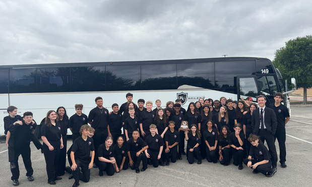 group band photo in front of the charter bus