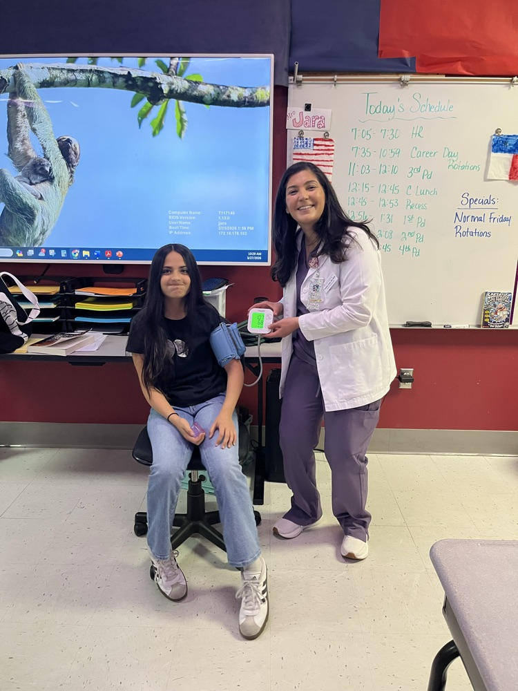 Student getting blood pressure taken by a doctor presenter