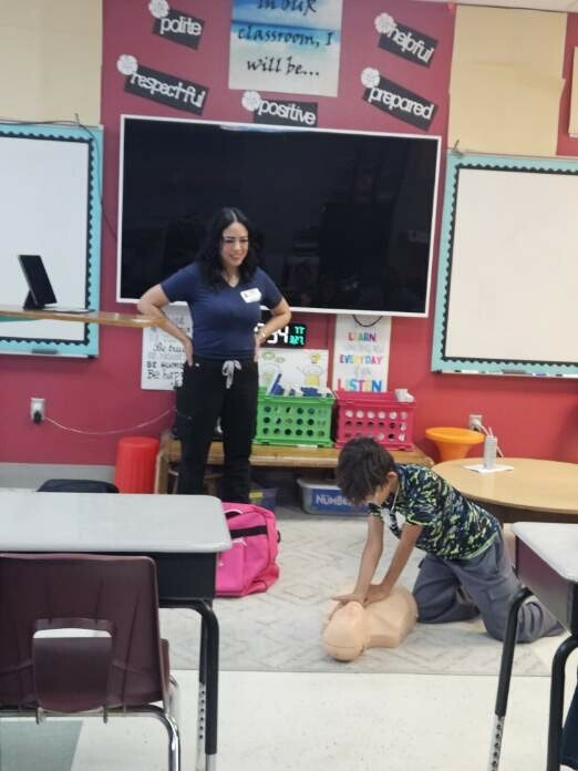 Student giving CPR on a dummy