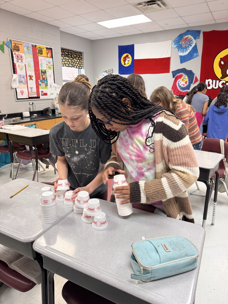 Two girls making their cup stack