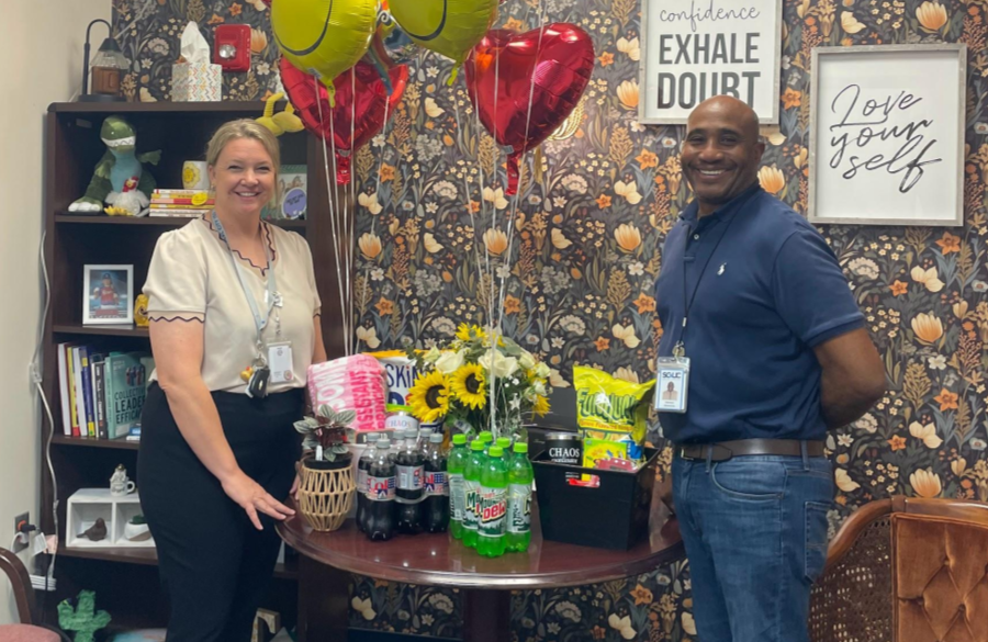 picture of Ms. Tims and Mr. Simmons posing with flowers, balloons, and treats for vice principal week