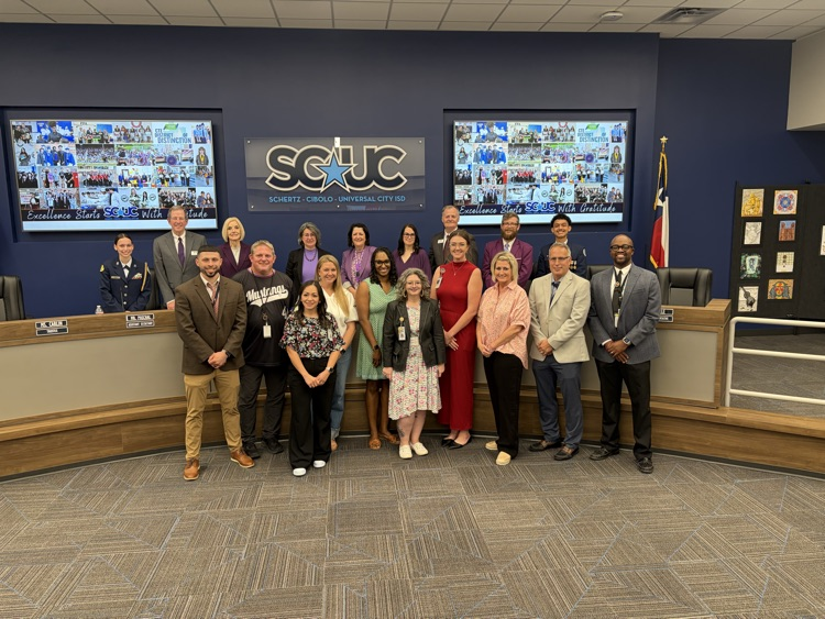 Group of adults gathered together at a board meeting. Our assistant principles are in the group.