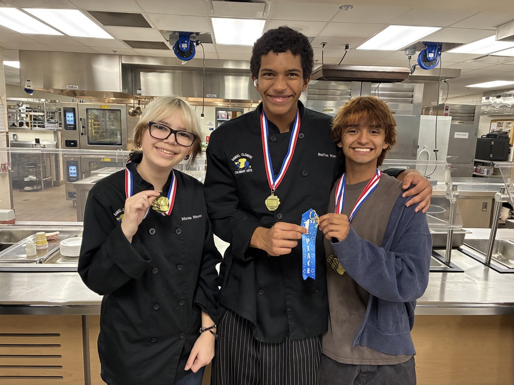 3 students holding first place ribbon