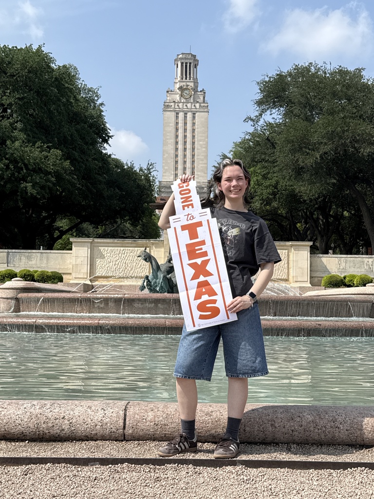 student holding UT sign