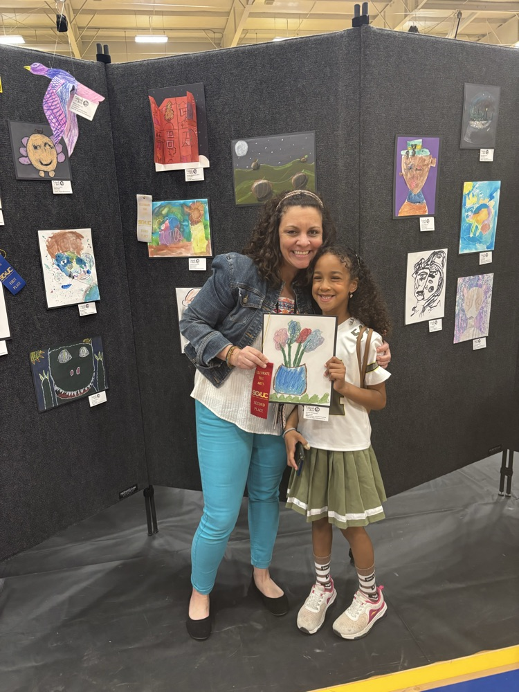 students and their art work at the art show 