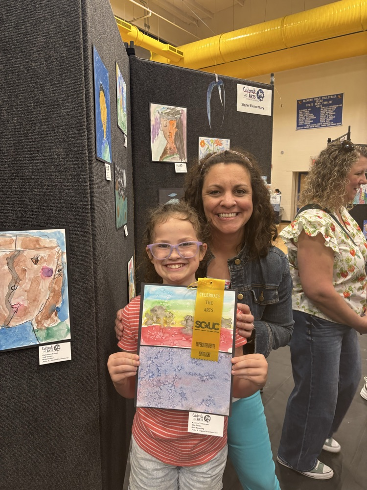 students and their art work at the art show 