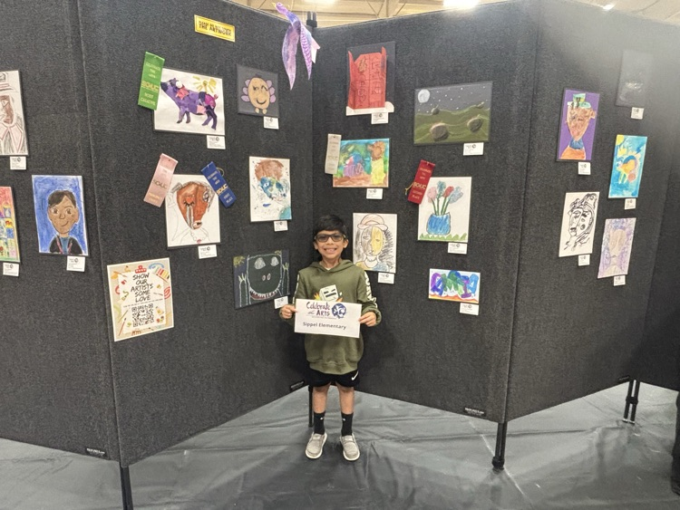 students and their art work at the art show 