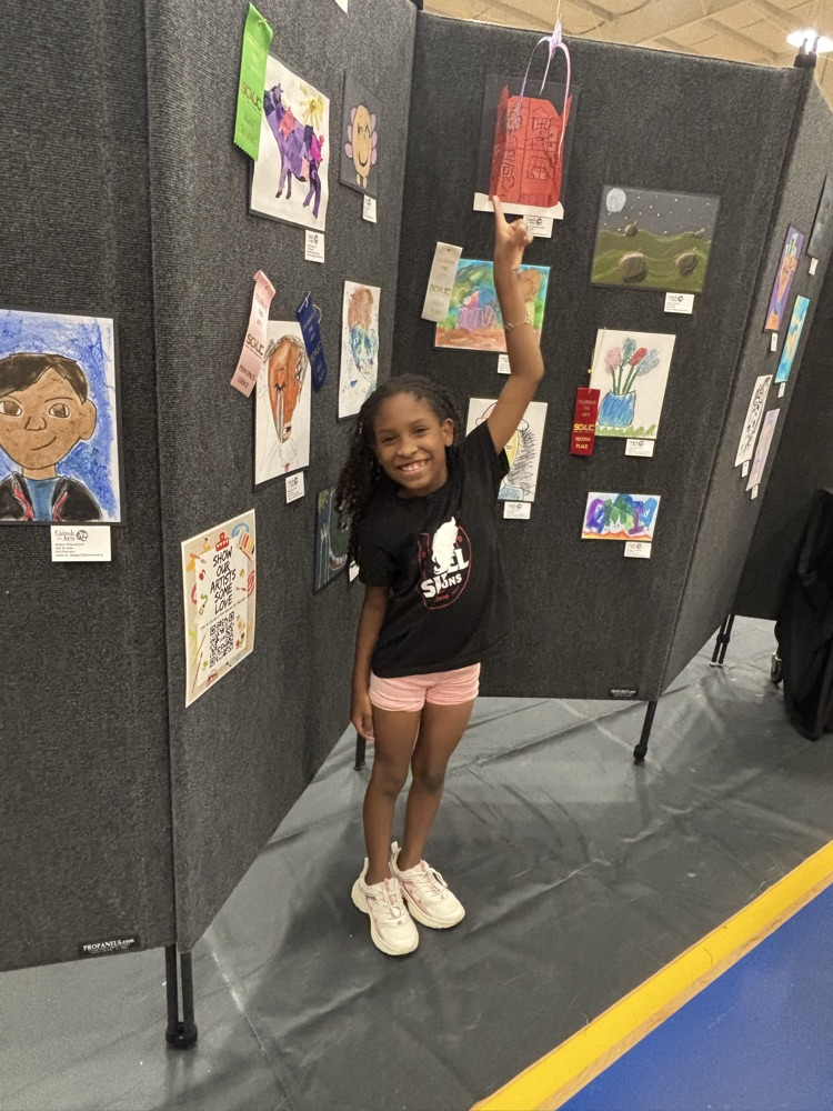 students and their art work at the art show 