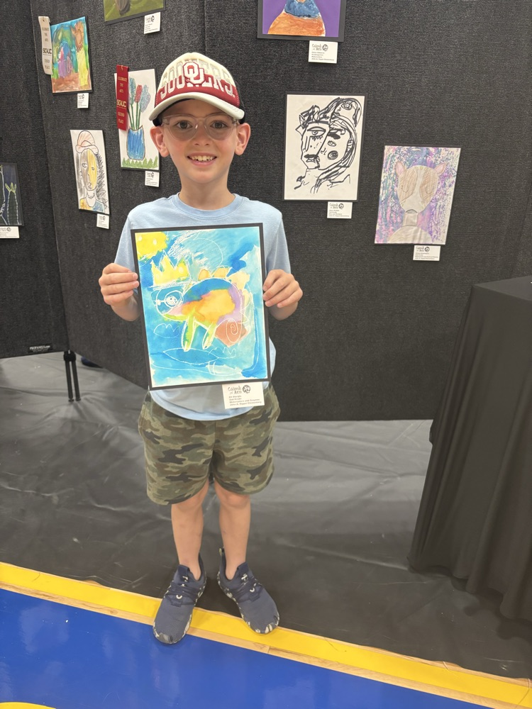 students and their art work at the art show 