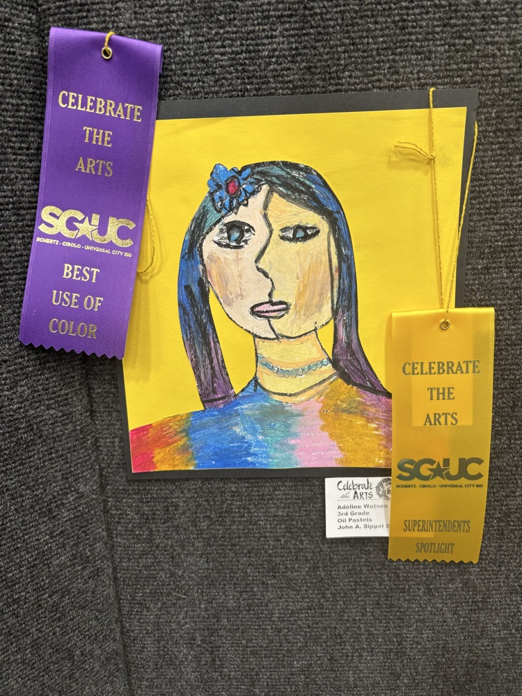 students and their art work at the art show 