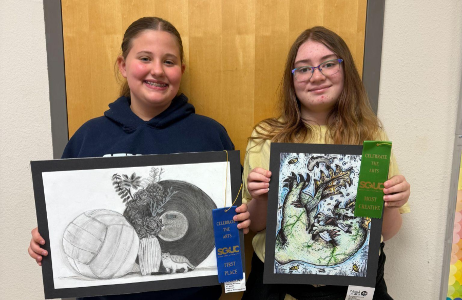 students posing with their awarded ribbons and artwork from the Celebrate the Arts show