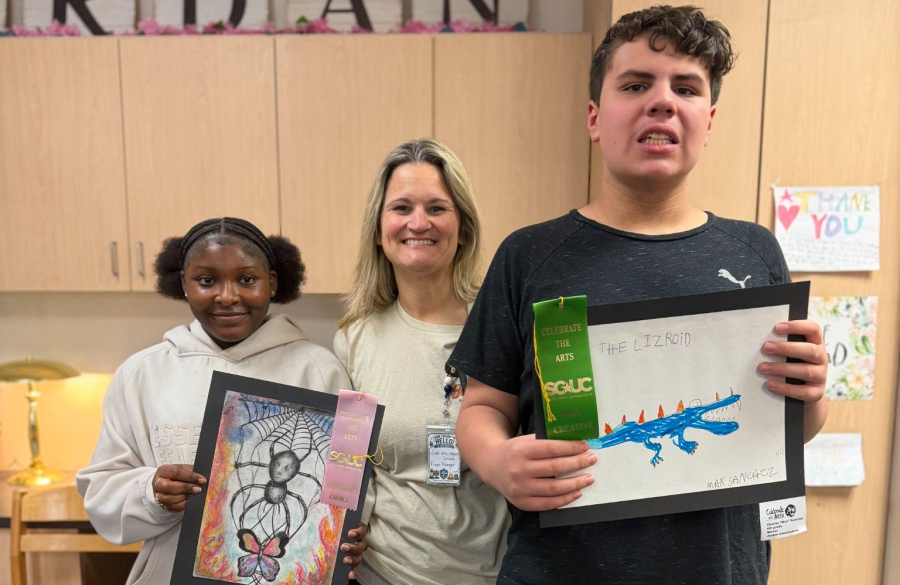 students posing with their awarded ribbons and artwork from the Celebrate the Arts show