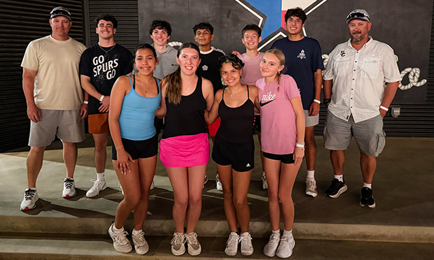 high school senior tennis players (5 boys,  3 girls) are flanked by the coaches on a stage at chicken n pickle