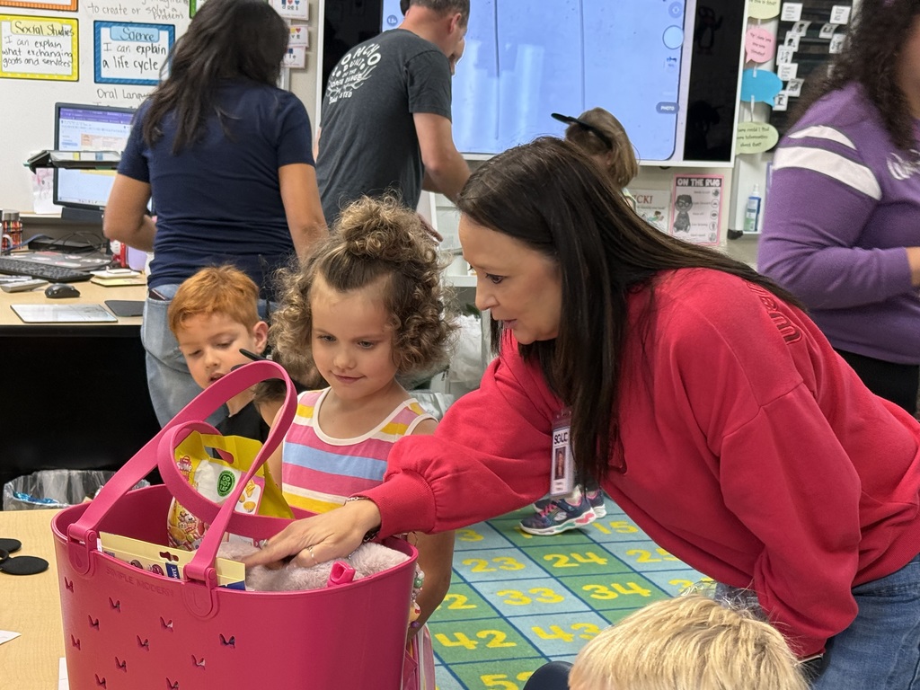 Carrigan peeks into her goodie bag with Wiederstein counselor Denise Orona