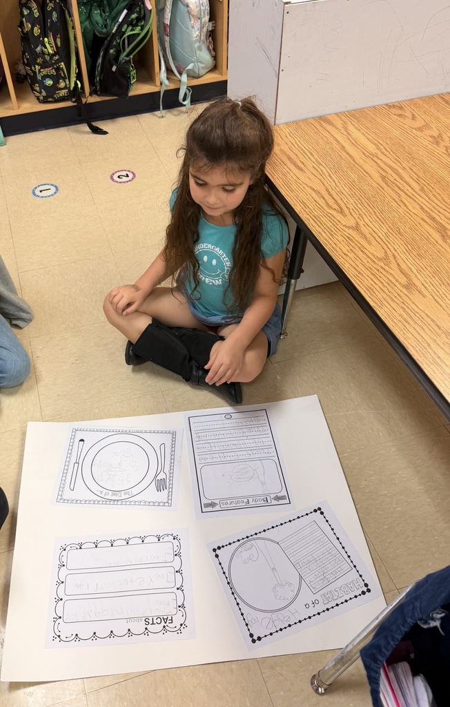 Kinder grizzlies showing off their animal projects to 4th graders. 