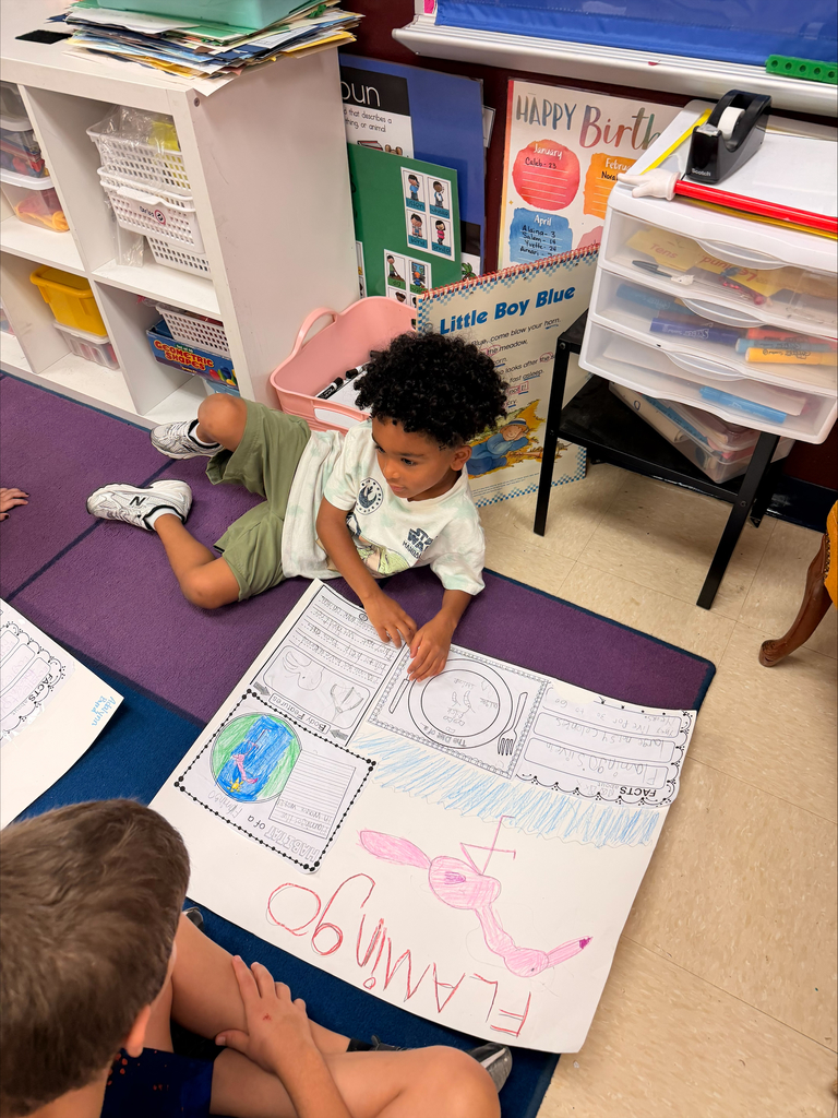 Kinder grizzlies showing off their animal projects to 4th graders. 