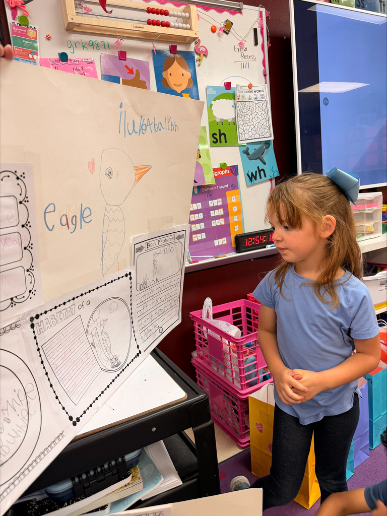 Kinder grizzlies showing off their animal projects to 4th graders. 