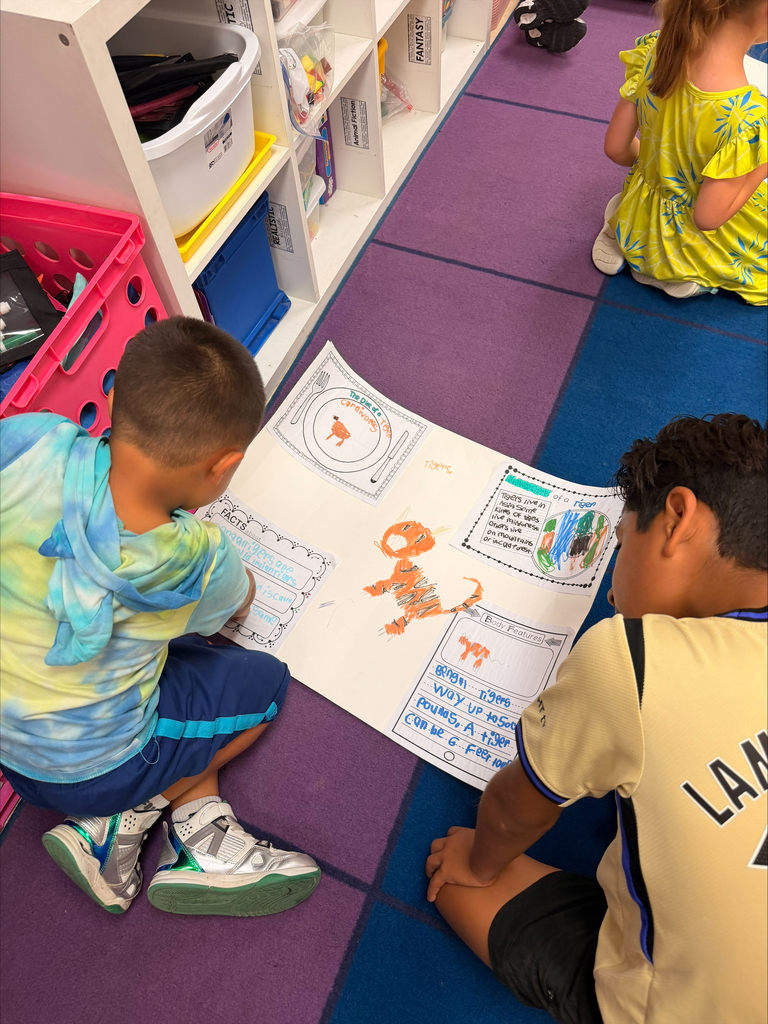 Kinder grizzlies showing off their animal projects to 4th graders. 