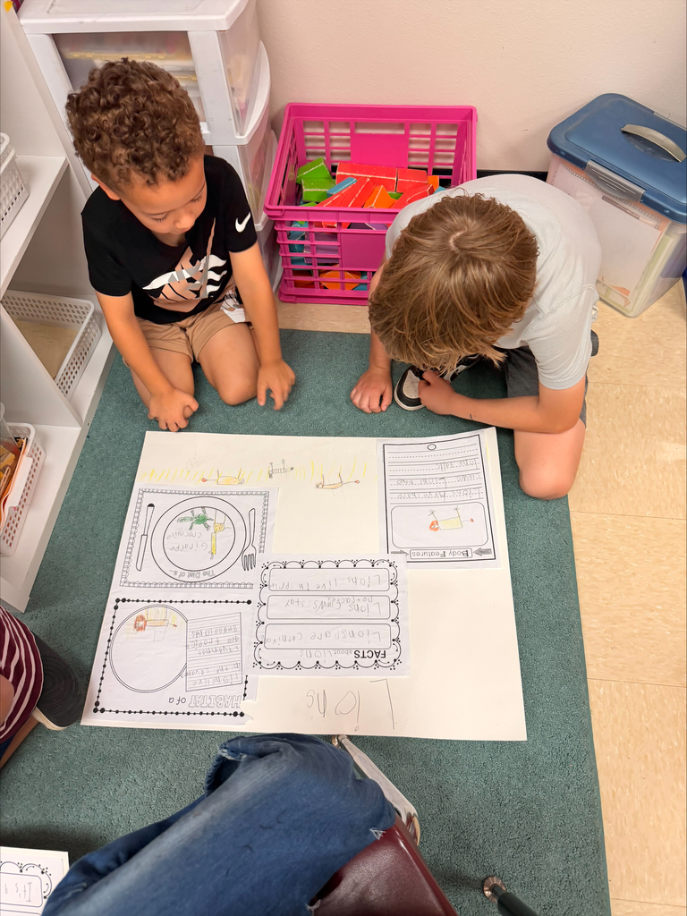 Kinder grizzlies showing off their animal projects to 4th graders. 