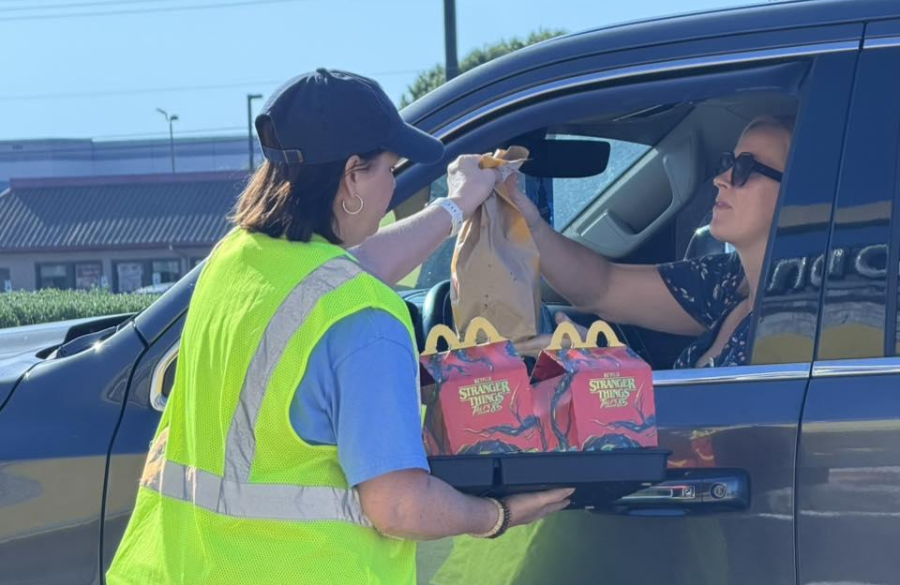 picture of a teacher delivering food to drive thru at McTeacher Night