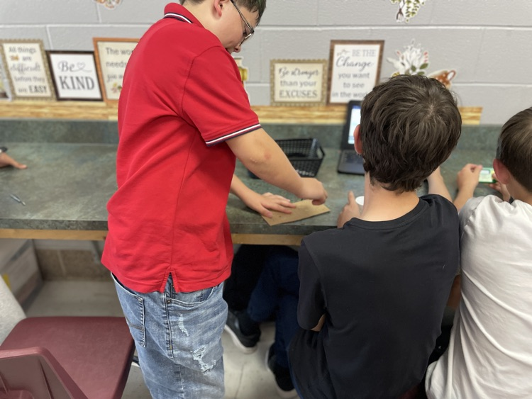 Students looking at cardboard measurements