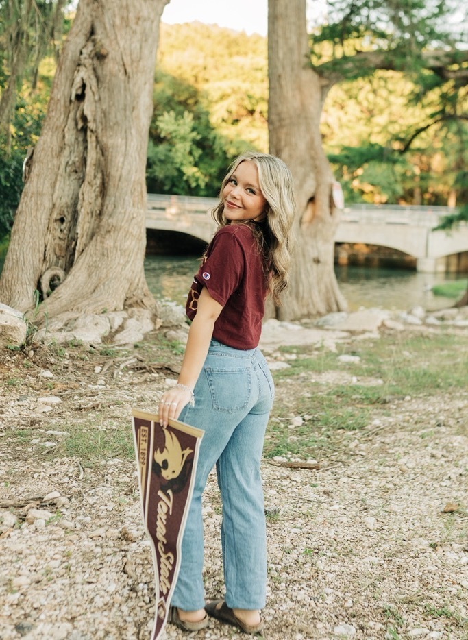 student holding texas state sign