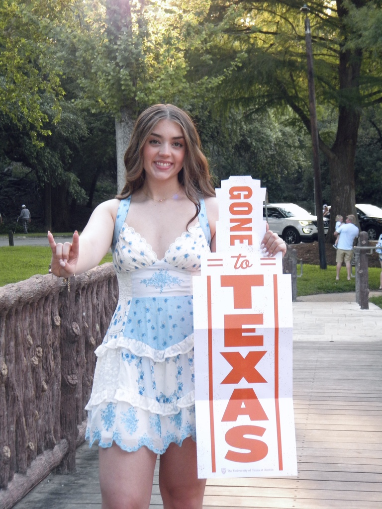 student holding UT sign