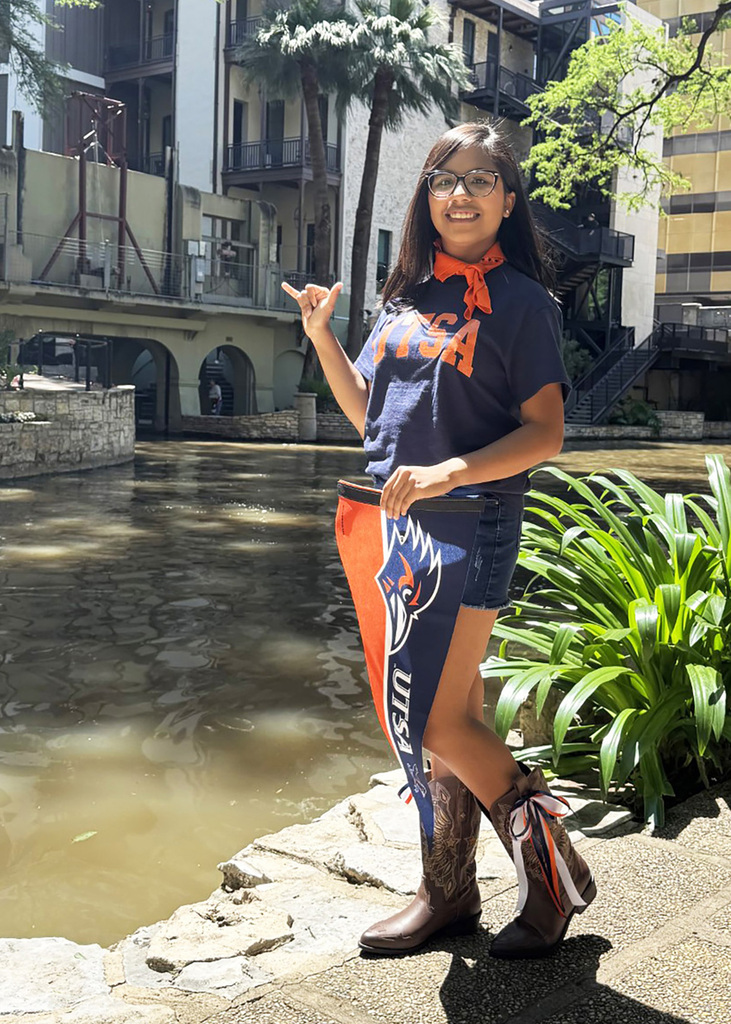 student holding UTSA sign