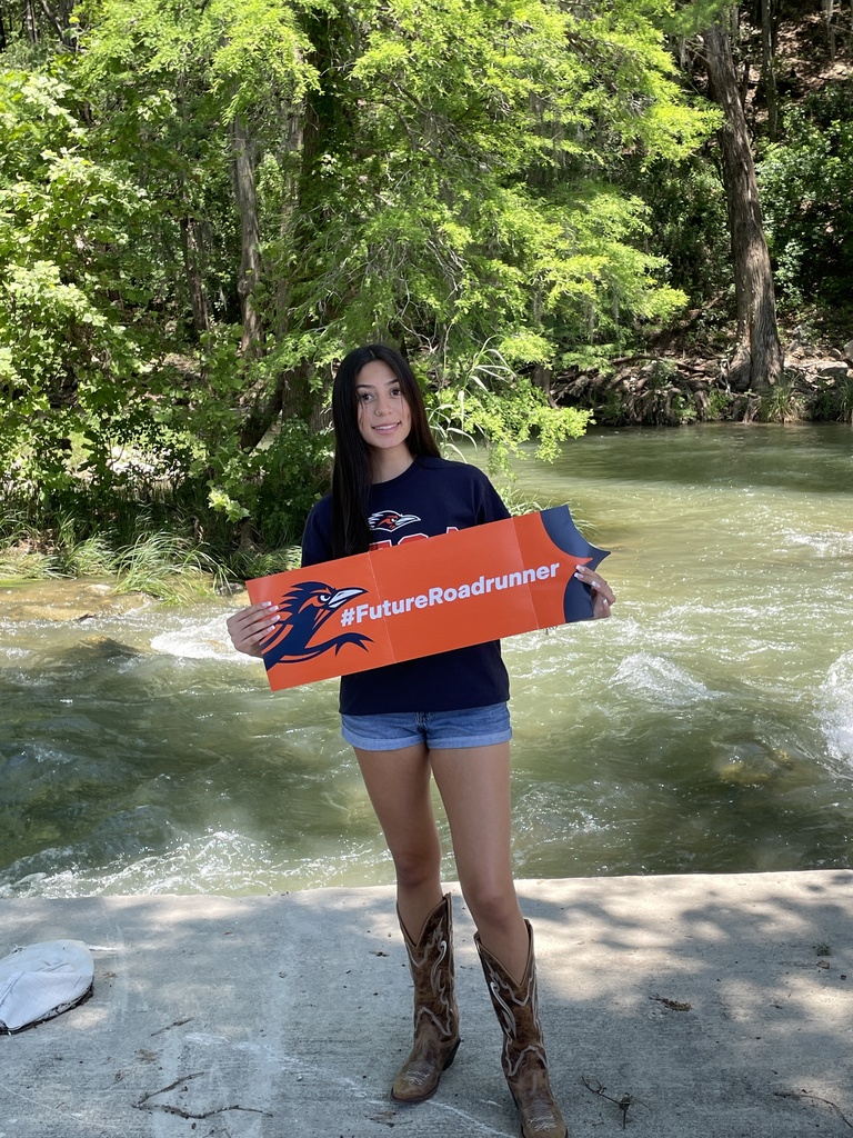 student holding a UTSA sign