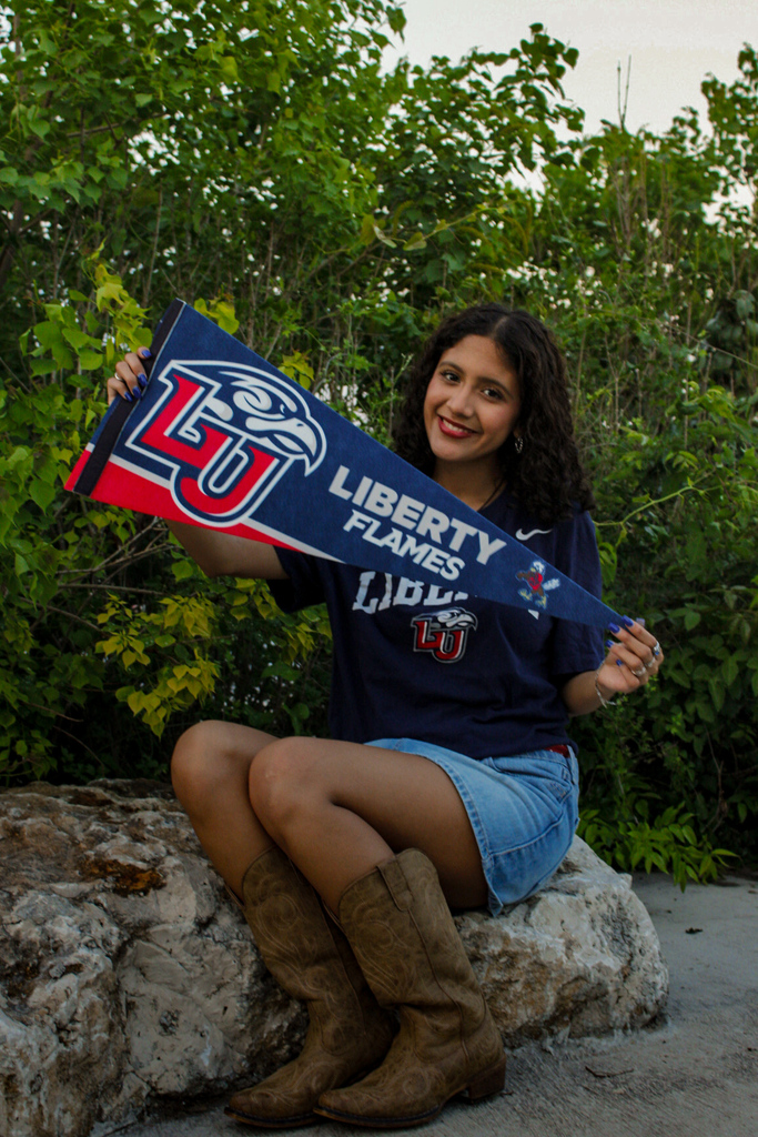 student holding a Liberty flames sign