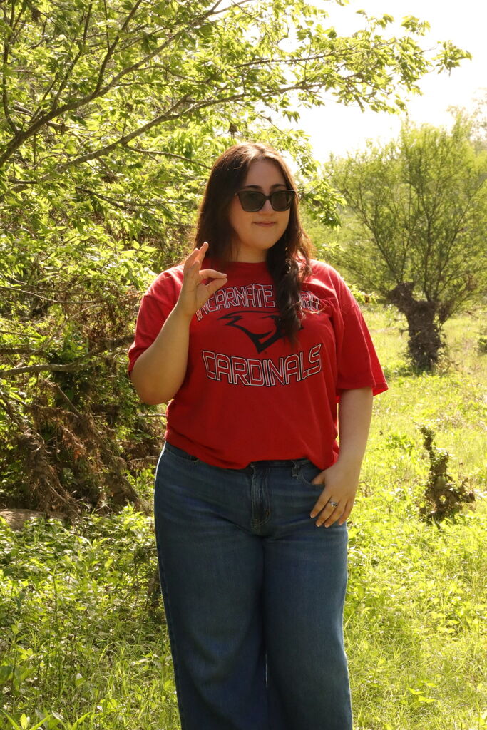 student wearing a UIW shirt