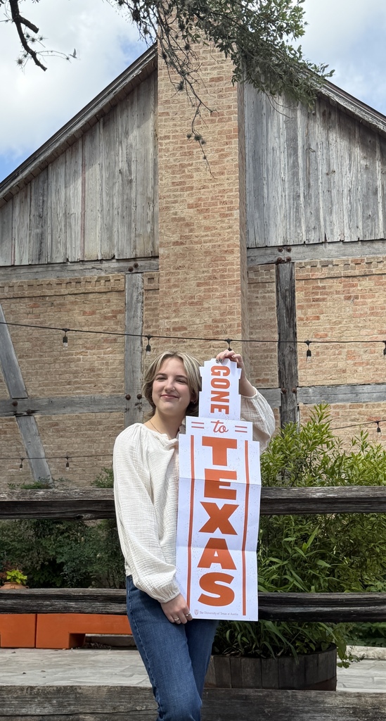 student holding UT sign
