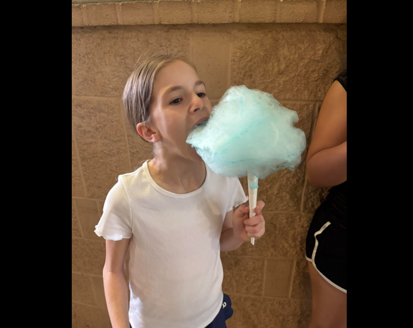 girl eating cotton candy