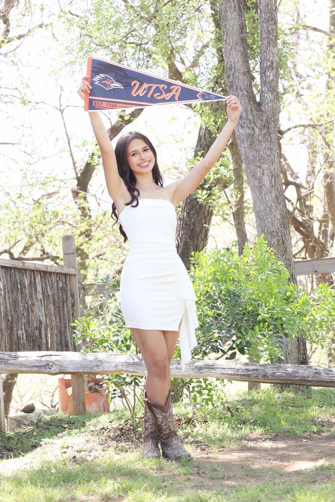 student holding UTSA sign
