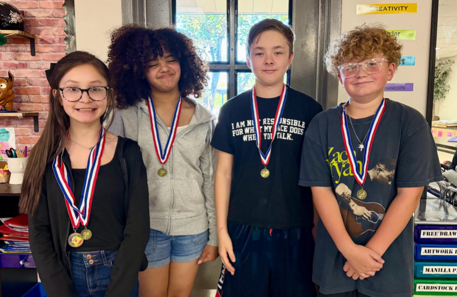 picture of students posing with their medals