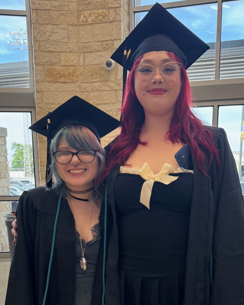 tow friends dressed in cap and gown 