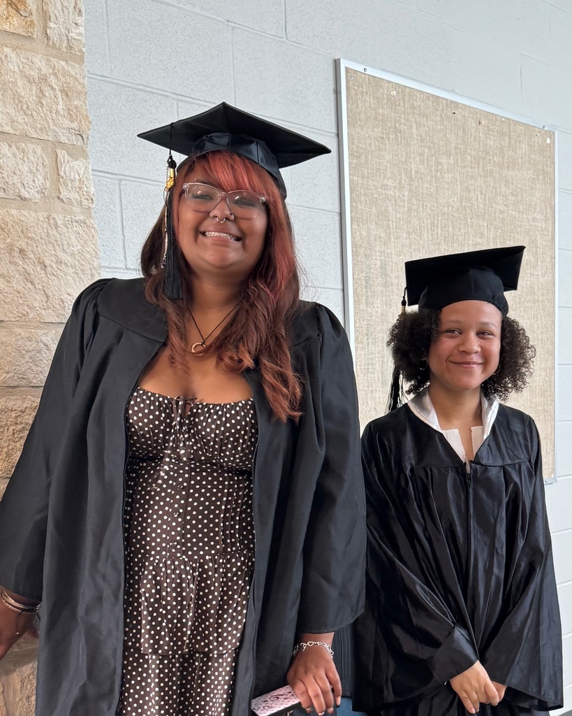 two female  students dressed up pose for picture