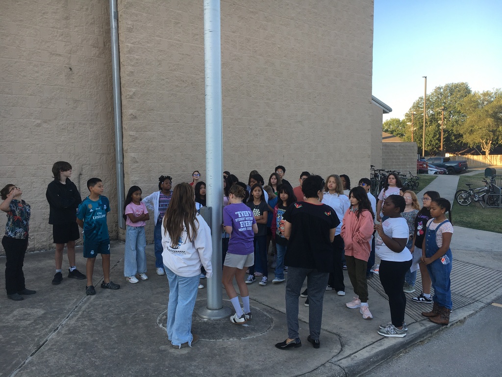students around flag pole