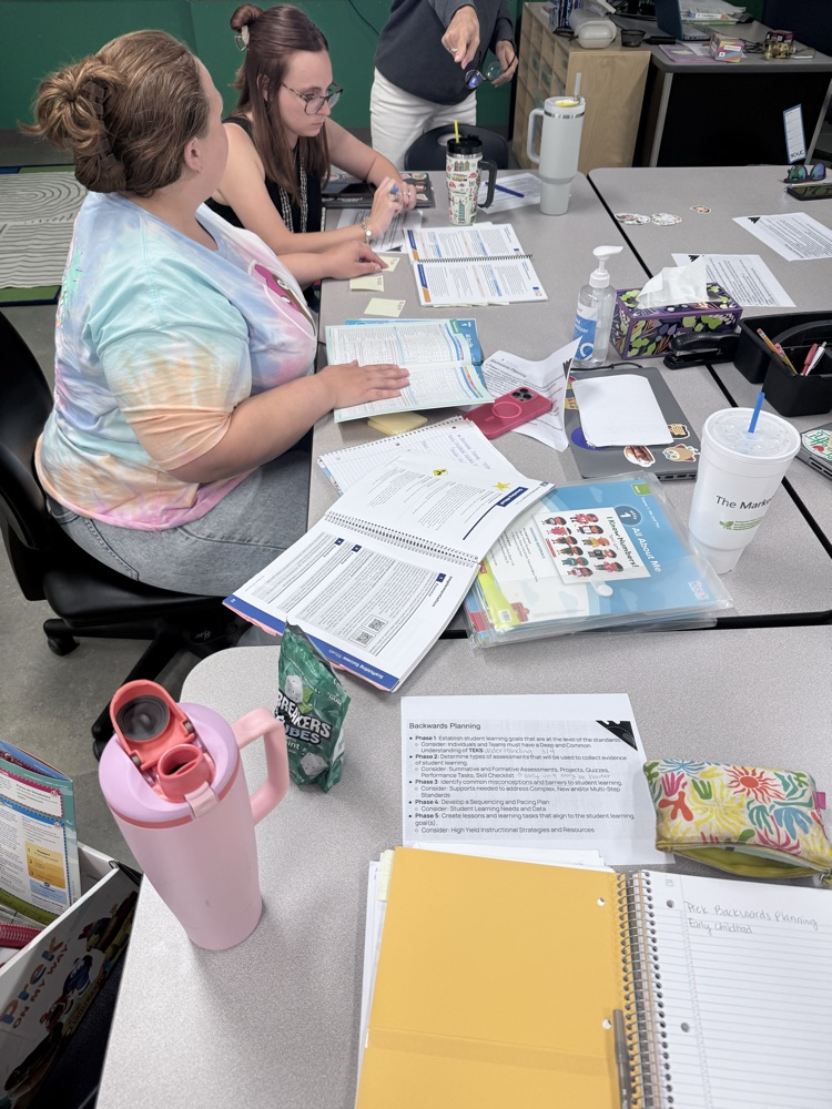 PreK pouring over their guidelines and curriculum resources  
