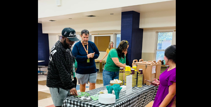 the coaches and counselor getting coffee and paper plates