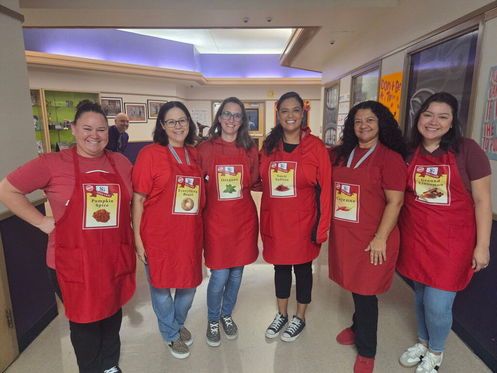 six para professional teachers wearing different spice aprons
