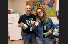 Mr. Jackson and Mrs. Sprouse holding up prizes