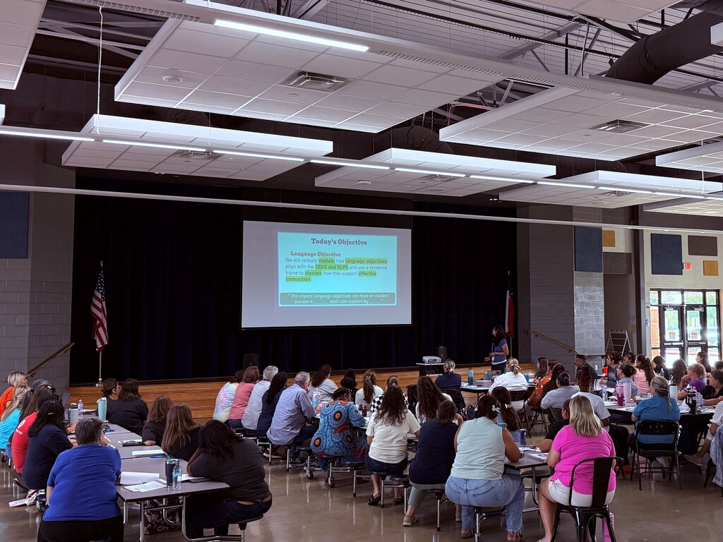 Large group of teachers in a meeting.