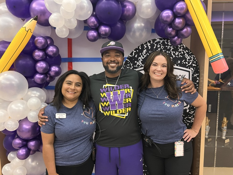 3 staff members taking a. picture 